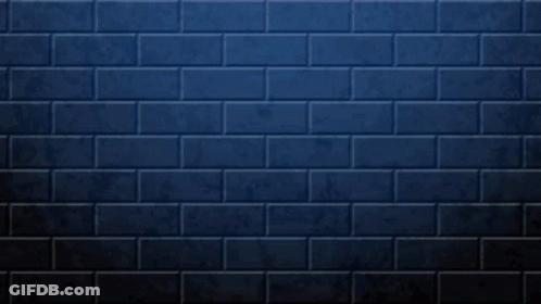 Hand Giving Peace Sign Blue Brick Wall GIF