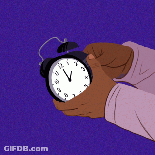 Hand Holding Alarm Clock At 12 And 1 GIF