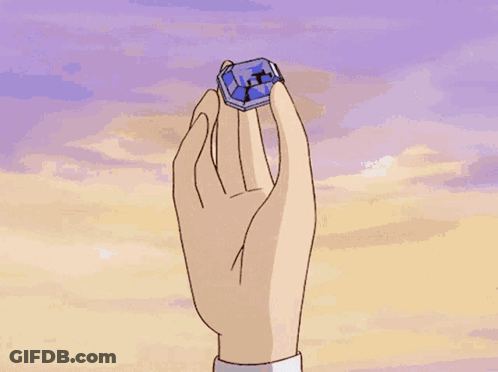 Hand Holding Blue Object With Letter X GIF