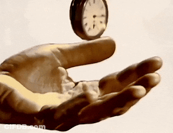 Hand Holding Clock Showing 1 And 5 GIF