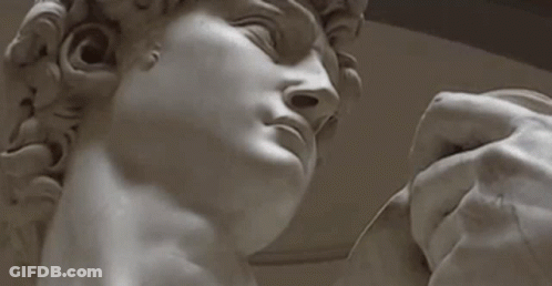 Hand Holding Man Statue Eyes Closed GIF