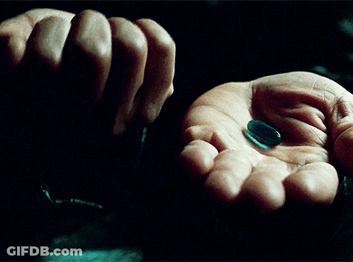 Hand Holding Red And Blue Pills GIF