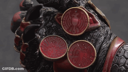 Hand Holding Three Red Coins With Dragon GIF
