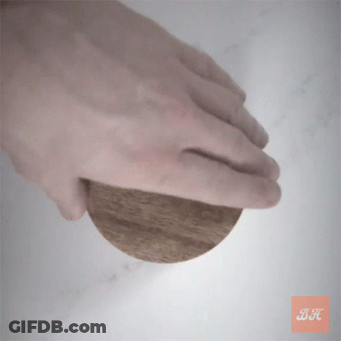Hand Holding Wooden Circle With Letter BK GIF