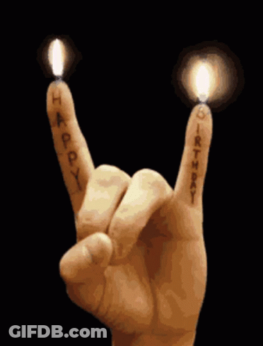 Hand Making Rock And Roll Sign With Candles GIF