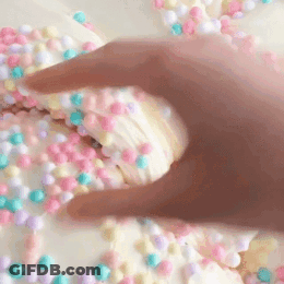 Hand Reaching For Cookie With Sprinkles GIF