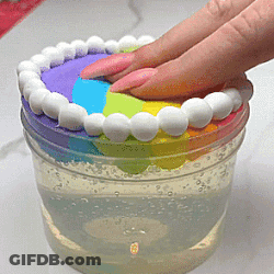 Hand Reaching For Rainbow Item In Container GIF