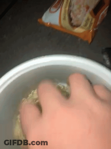 Hand Reaching Into Bowl Of Noodles GIF