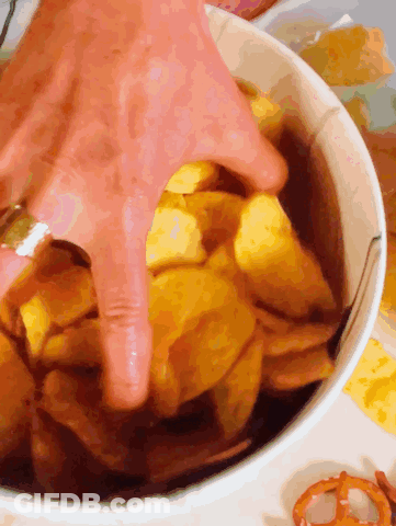 Hand Reaching Into Bowl Of Potato Chips GIF