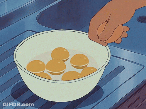 Hand Reaching Into Bowl Of Yellow Balls GIF