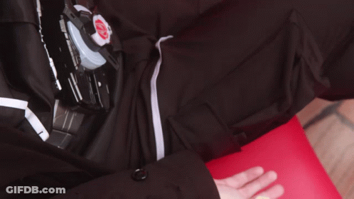 Hand Reaching Toward Black Shirt With Red K GIF