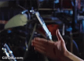 Hands Holding Cigarette Near Drum Set GIF