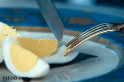 Hard Boiled Egg Cut In Half With Knife And Fork GIF