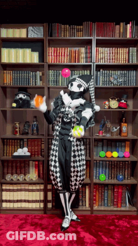 Harlequin Juggling Balls Near Bookshelf GIF