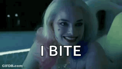 Harley Quinn From Suicide Squad Is Smiling And Says `` I Bite '' While Sitting In A Bathtub . GIF