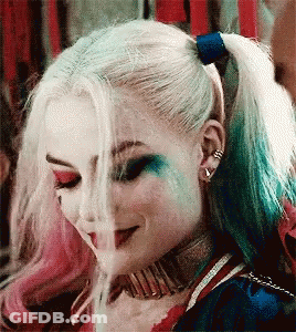 Harley Quinn From Suicide Squad Is Smoking A Cigarette While Wearing A Ponytail . GIF