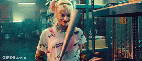 Harley Quinn Holding Bat In Garage GIF