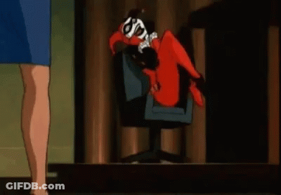 Harley Quinn Is Laying On Her Back In A Chair While A Woman Stands Next To Her . GIF
