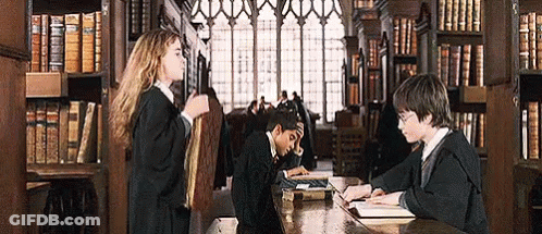 Harry Potter And Hermione Granger Are Sitting At A Table In A Library Reading Books . GIF