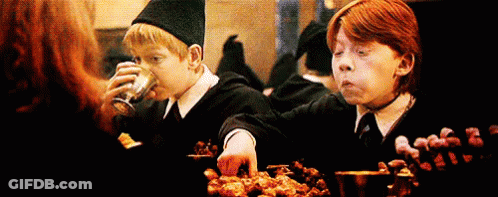 Harry Potter And Ron Weasley Are Sitting At A Table Eating Food And Drinking . GIF