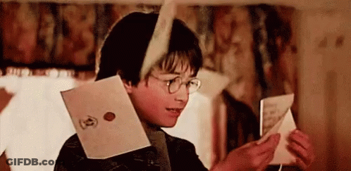 Harry Potter Is Reading A Letter From Harry Potter While Wearing Glasses . GIF