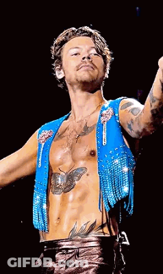 Harry Styles Blue Vest With Fringe And Chest Tattoo GIF