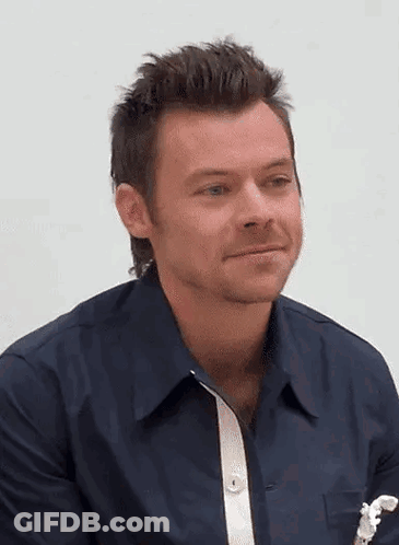 Harry Styles In Blue Shirt With White Stripe Sleeves GIF