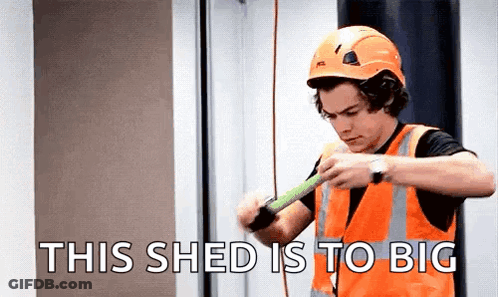 Harry Styles In Hard Hat And Safety Vest Measuring Wood GIF
