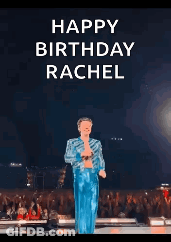 Harry Styles Is Standing On A Stage With His Arms Outstretched . GIF