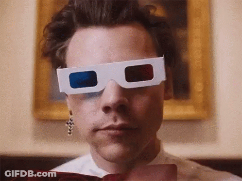 Harry Styles Is Wearing A Pair Of 3D Glasses In Front Of A Painting . GIF