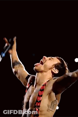 Harry Styles Singing Into Microphone Shirtless On Stage GIF