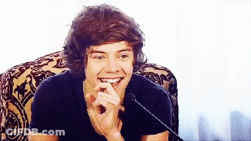 Harry Styles Smiling In Chair GIF