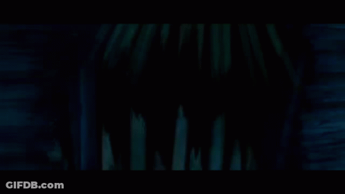 Haunted House Surrounded By Trees And Fence At Night GIF