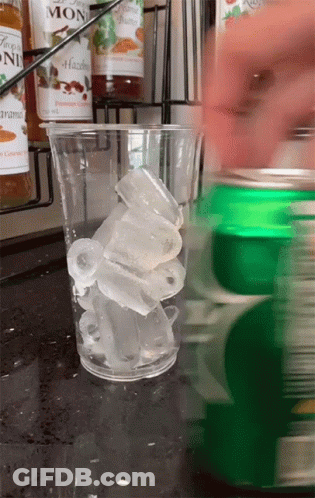 Hazelnut Syrup Pouring Into Glass Of Ice Cubes GIF