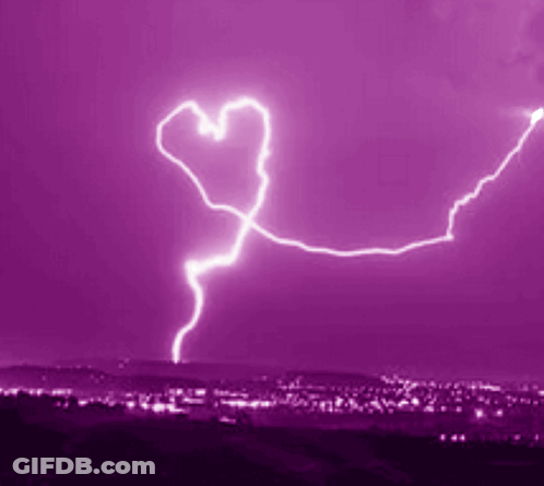 Heart-Shaped Lightning Bolt In Purple Sky Over City GIF