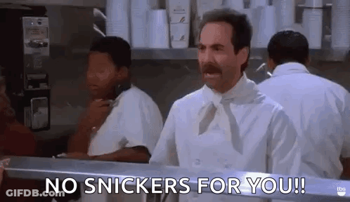 Heart Shaped Mirror Reflecting Snickers Bar Being Eaten GIF