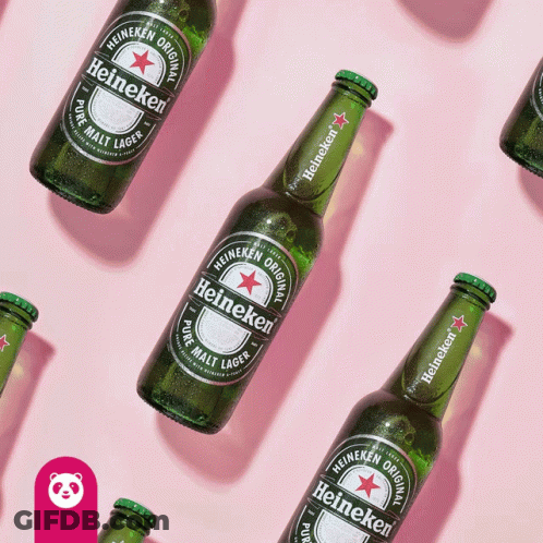 Heineken Bottles Lined Up On Pink Surface GIF