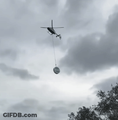 Helicopter Carrying Sign Saying A GIF