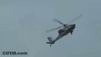Helicopter Flying Through Cloudy Sky GIF