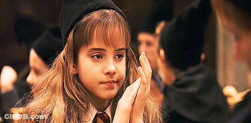 Hermione Granger From Harry Potter Is Wearing A Hat And Tie And Is Holding Her Hands Together . GIF