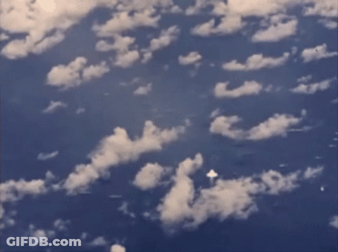High-Altitude Bomb Explosion Amidst Clouds GIF