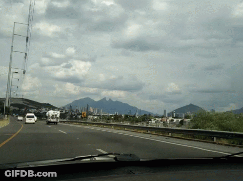 Highway With Mountains And City GIF