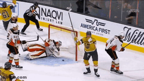 Hockey Game In Front Of America First Credit Union Ad GIF