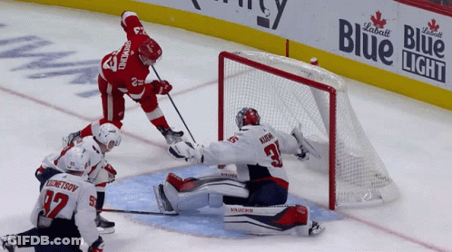 Hockey Game In Front Of Blue Light Banner GIF