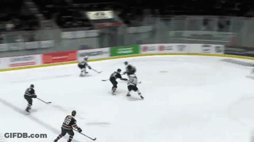 Hockey Game In Front Of Blue Light Banner GIF