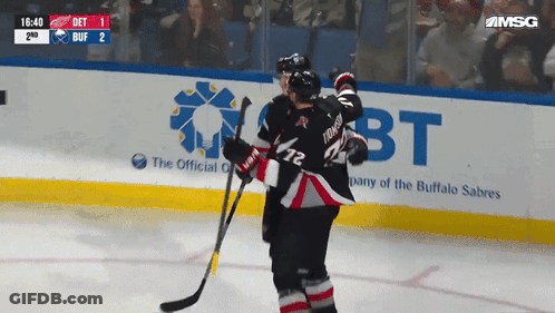 Hockey Game In Front Of Buffalo Sabres Banner GIF
