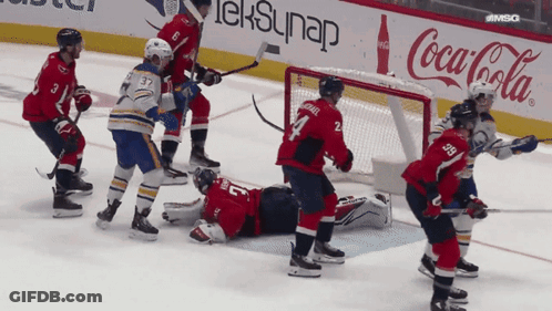 Hockey Game In Front Of Coca Cola Sign GIF