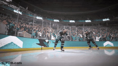 Hockey Game In Front Of Crowd With Scoreboard GIF