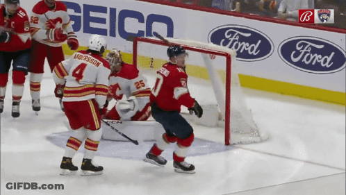 Hockey Game In Front Of Geico And Ford Ads GIF