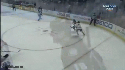 Hockey Game In Front Of Geico Banner GIF